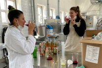 2 Frauen testen Saft in Großküche.